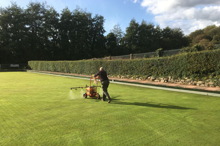 Person pushing liquid spraying machine