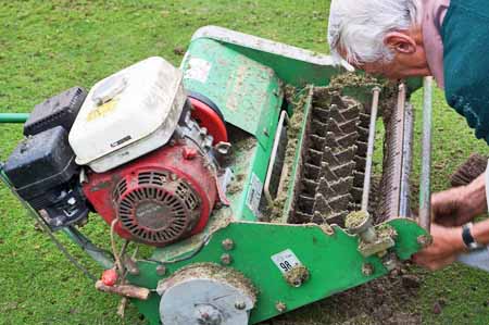 person adjusting scarifier 