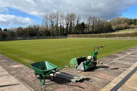 Mower at side of green