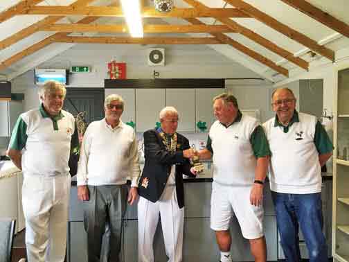 4 bowlers with a trophy