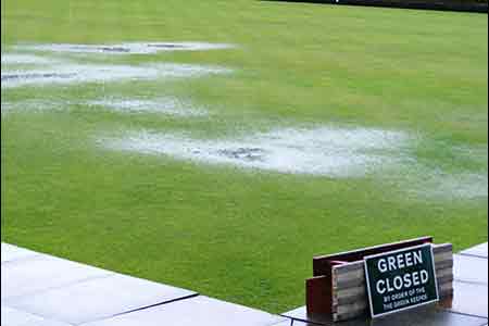 A green with pools of water on it